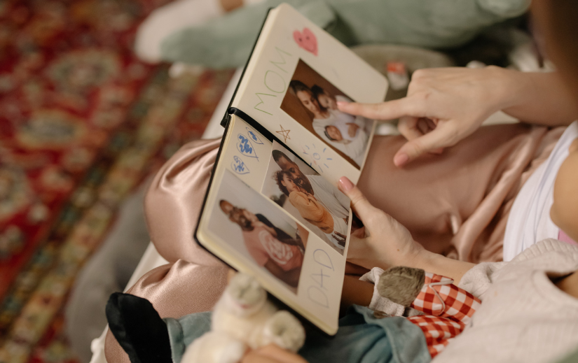  Child and parent looking through a scrapbook, emphasizing visual storytelling and creating meaningful memories.